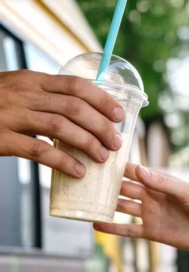 A student holding an iced drink