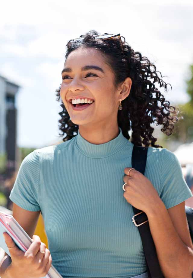 A smiling student with a backpack