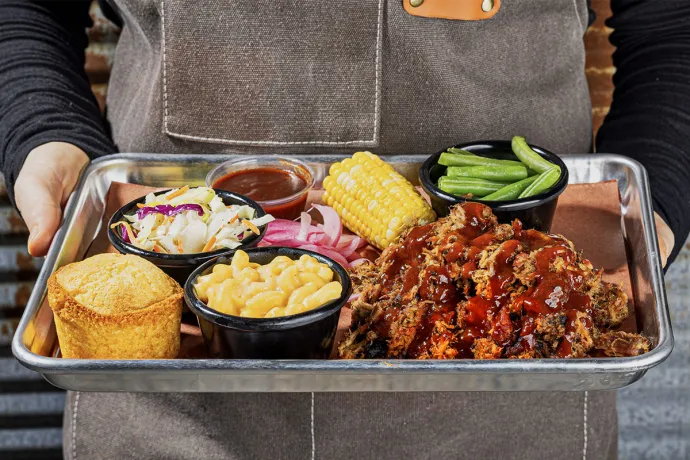 bbq tray with chicken, corn bread, corn, beans and more