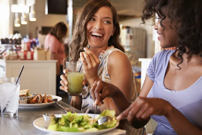 two students eating and laughing